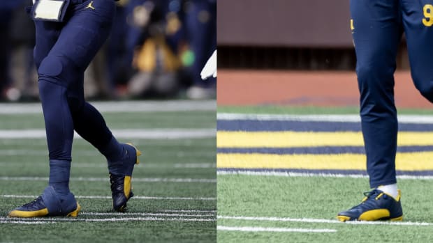 Michigan Wolverines quarterback J.J. McCarthy's navy and maze Air Jordan cleats.